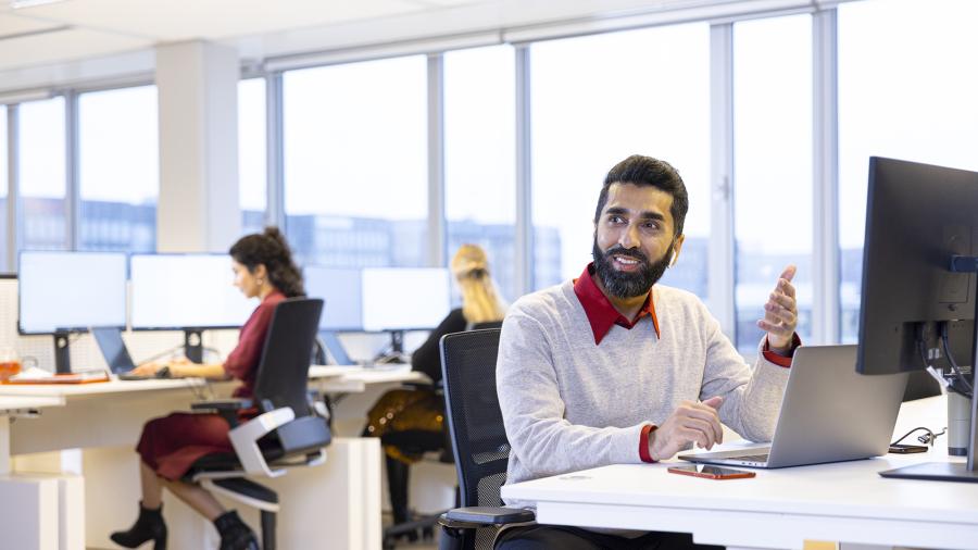 Man behind laptop in office